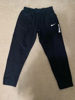 Nike Black Jogger Pants with White Swoosh and Stripe Accents